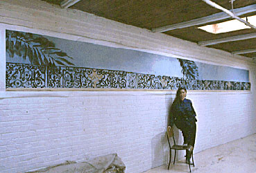 skybalcony.jpg , Carol Sutton, self portrait in front of painting in her studio; title: Sky Balcony, 3 by 28 feet or 32 1/2